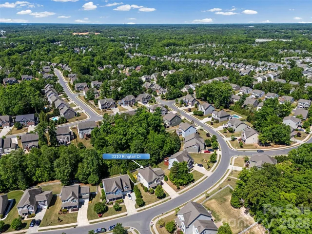 Aerial view of mature trees and pocket park across from home