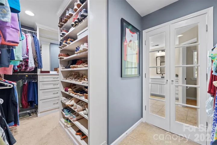 Primary closet w/ custom shelves is a beauty! 