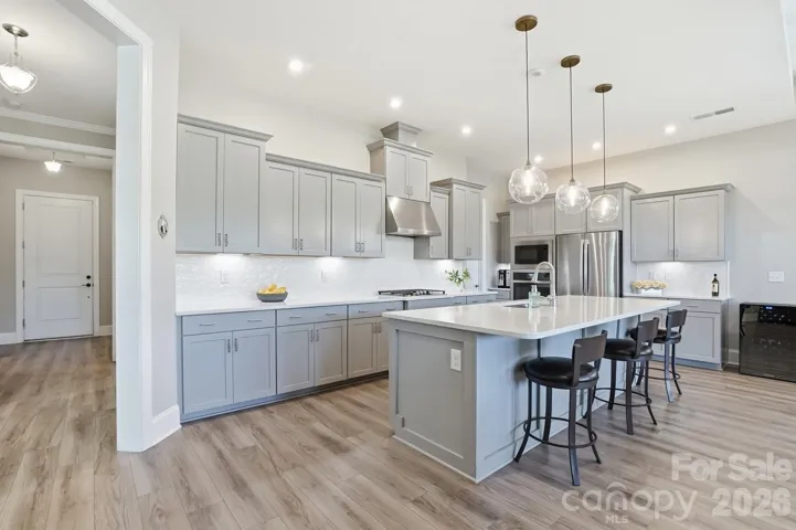Chef’s kitchen featuring select cabinets with convenient pull-out shelving.
