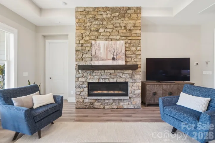 This sleek linear stone fireplace delivers winter warmth or ambient color for a modern or cozy, inviting feel.