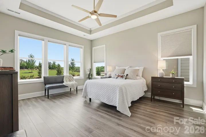 Large primary suite with abundant windows, creating a bright and airy retreat.