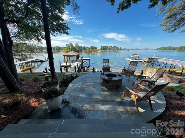 Waterfront patio and covered dock and pier  with newly added floating dock for jet skis.