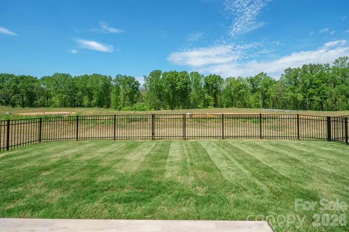 Fenced Backyard Overlooking Pond
