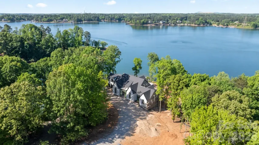 New custom home with over 500' of shoreline and expansive main channel Lake Norman views