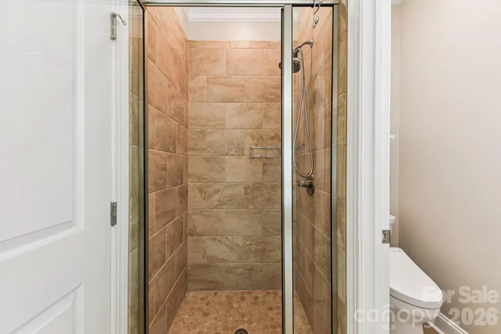 Tile shower in primary and separate toilet closet