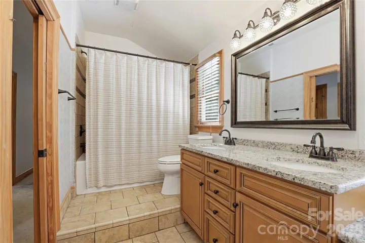 Upstairs bathroom with built-ins for ample storage.