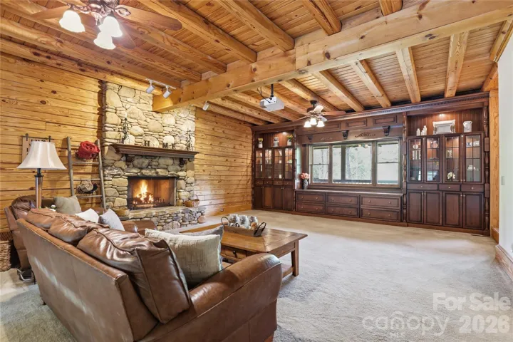 Great room with built-in, large drop down screen and projector, with gas fireplace.