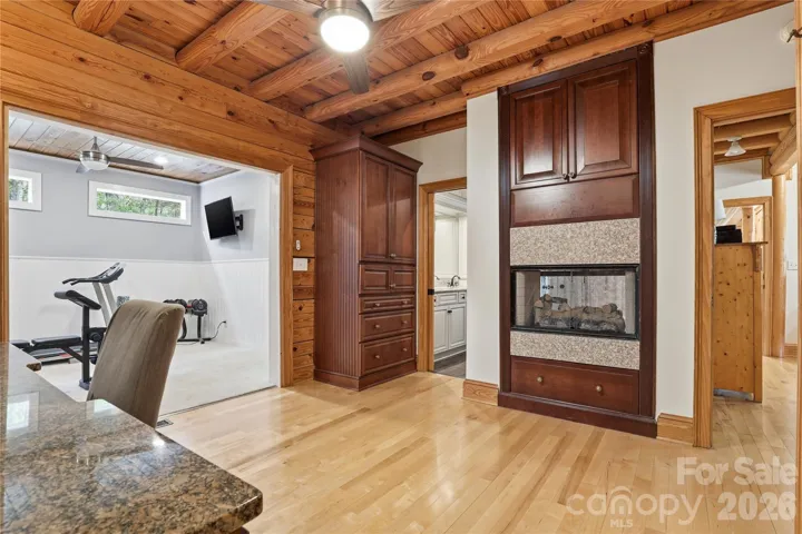 Changing room, workout room, see-through fireplace to shower in primary bathroom.