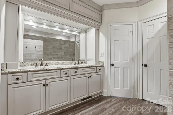 Primary Bathroom with double sinks with private water closet.