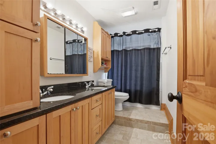 Upstirs bathroom with built-ins for ample storage.