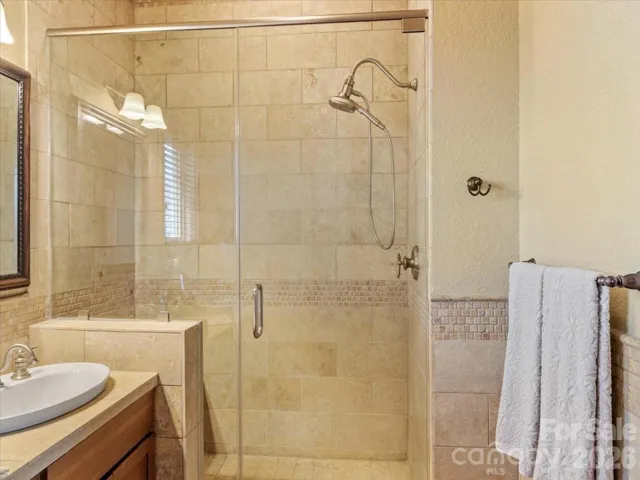 Glass enclosed shower.