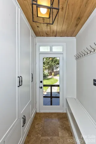 Hallway with storage leading to backyard 