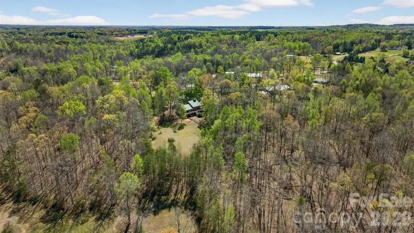 Looking for privacy and peace? 6+ acres surrounded by trees with barn and pasture.