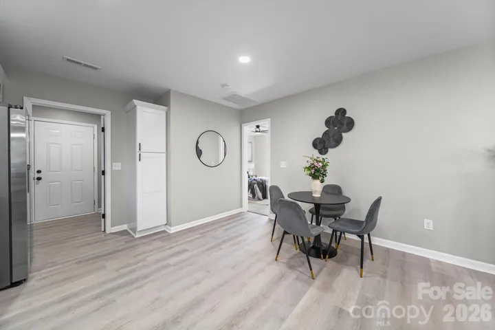 View from kitchen towards laundry room, built-in pantry and Primary bedroom 