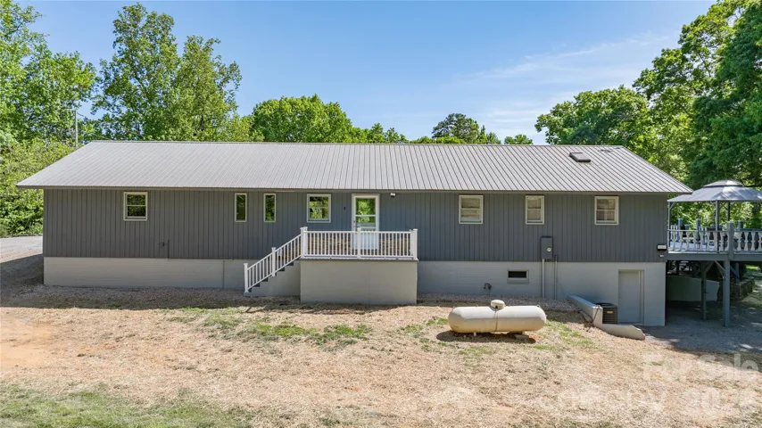 Back of home with entrance to basement