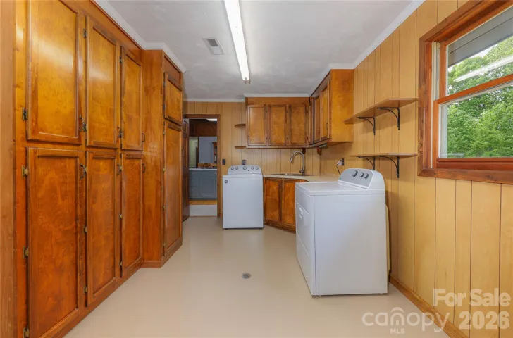 Laundry room with abundance of storage