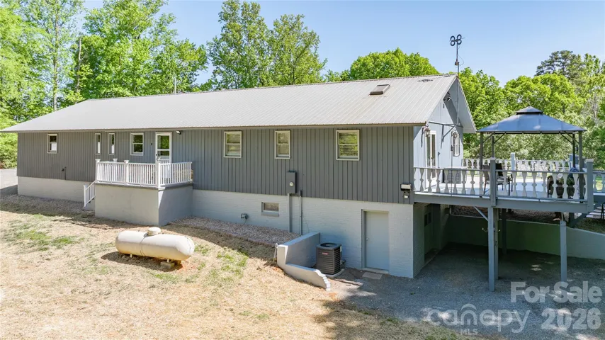 Back of home with entrance to basement