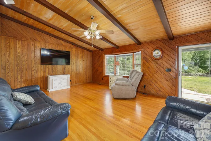 Den with hardwood floors