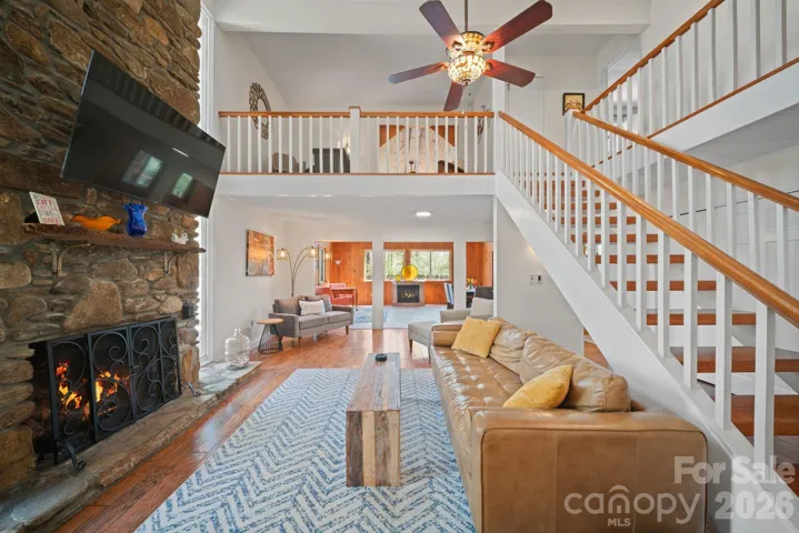 Sit in front of the gorgeous floor to ceiling rock fireplace
