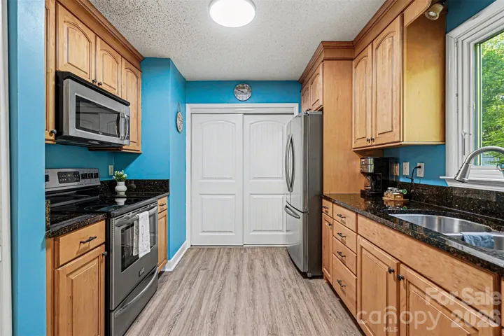 Beautiful SS appliances and sliding door to laundry closet