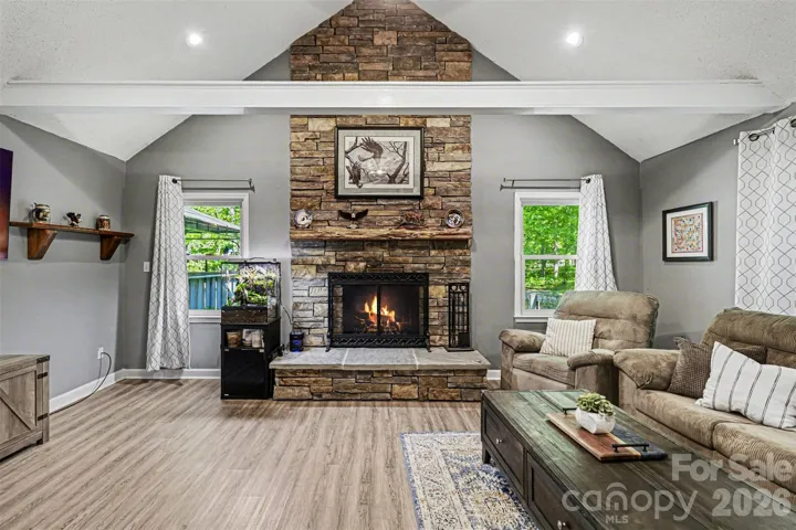 Ample living room with wood burning fireplace
