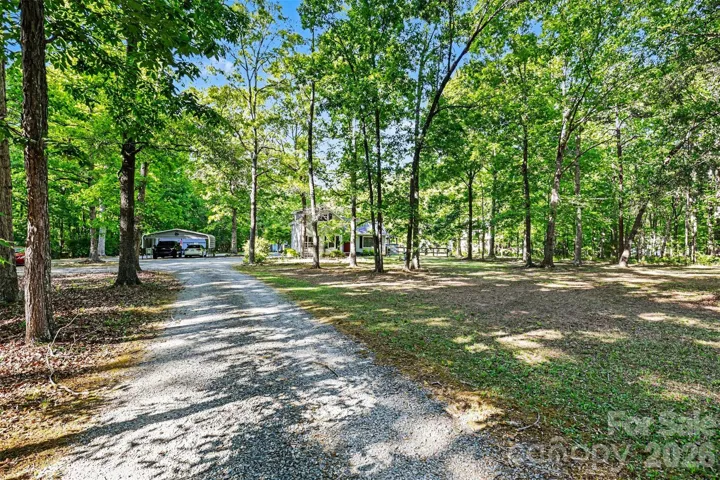 Gravel driveway leads you to your 2 vehicle carport