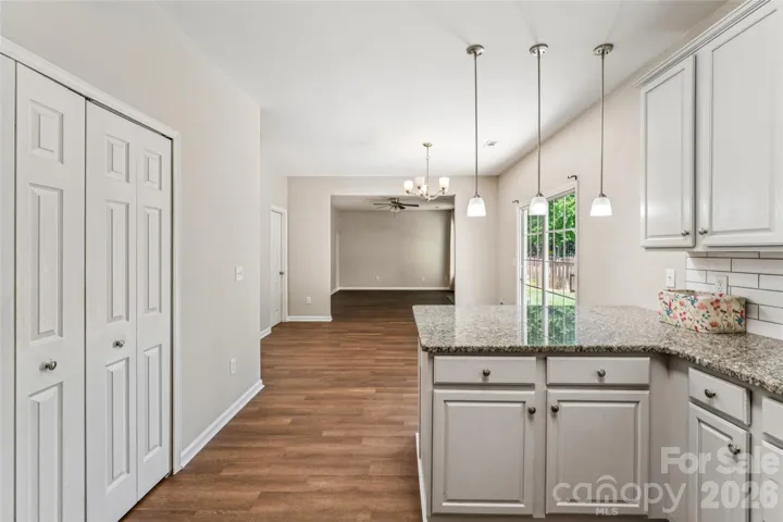 Kitchen view into dining area and living room