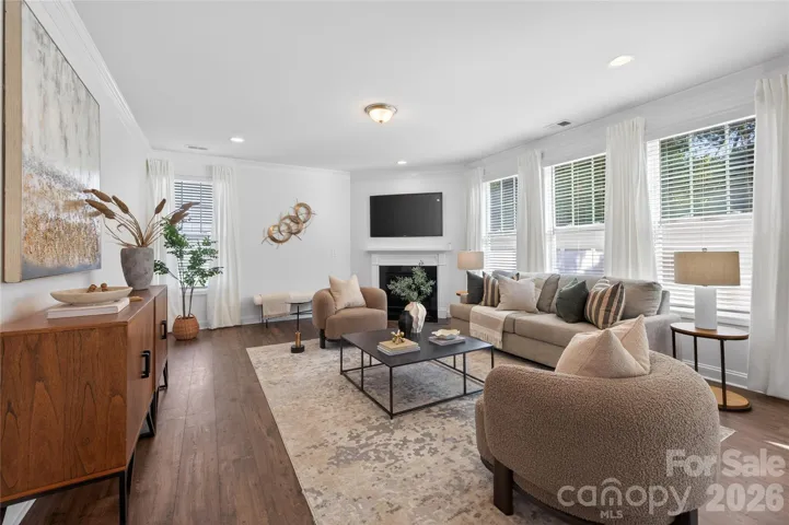 Beautifully appointed living room featuring gas fireplace and tons of natural light