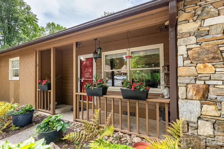 The front of the home is fully landscaped, and the covered porch is a lovely place to enjoy all the birds in the neighborhood.