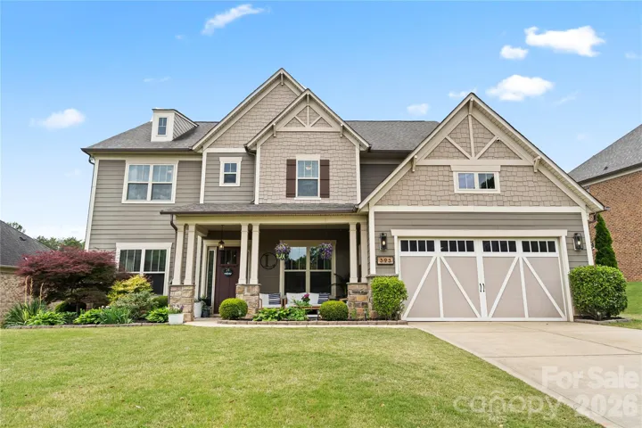 Front of home- covered porch, 3 car tandem garage