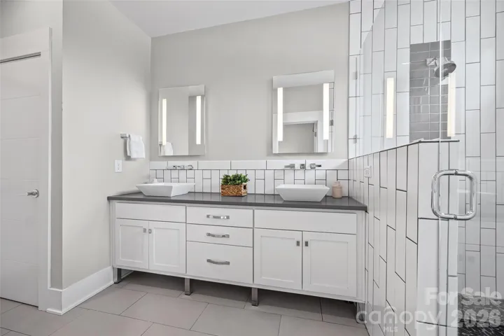 Stylish primary bathroom with dual vanities