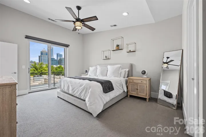 Primary bedroom with skyline views and your own balcony