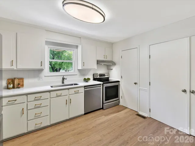 Kitchen with view of laundry closet and pantry