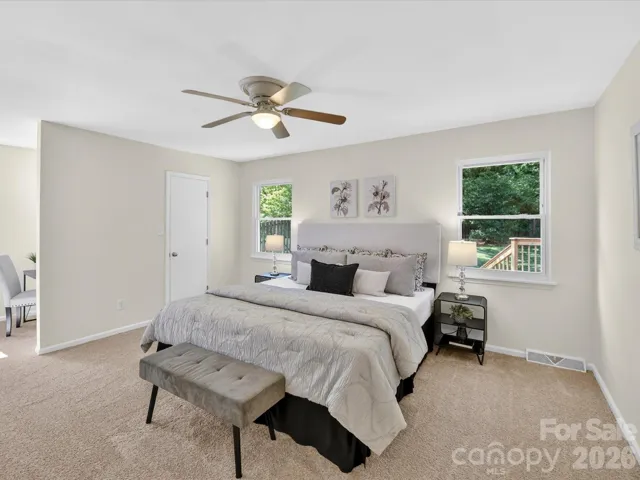 Primary bedroom overlooks backyard.