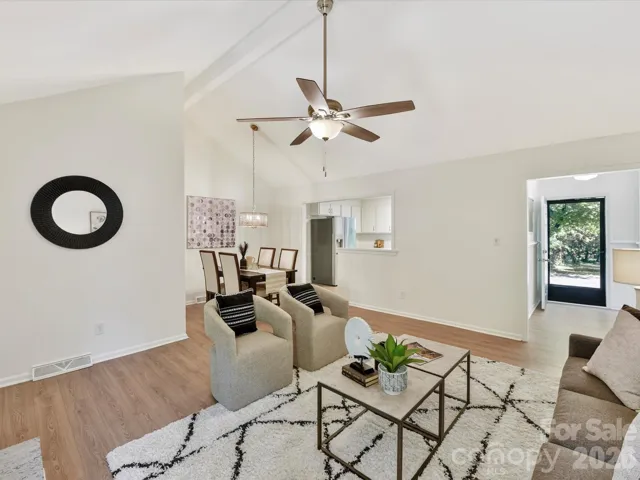 Family room with view of kitchen, dining area, and front hallway