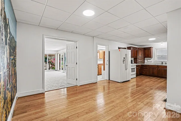 Kitchen with bamboo flooring, eat in dining area, fresh paint and updated lighting-