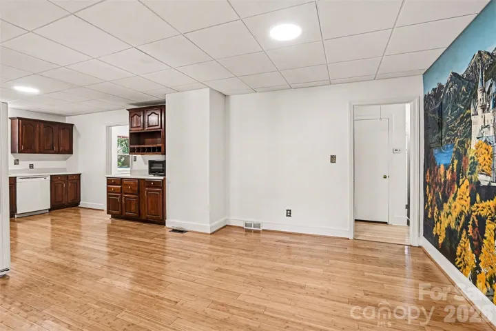 Kitchen has a very large eat in dining area- the wall on right has a painted mural ( not wallpaper)