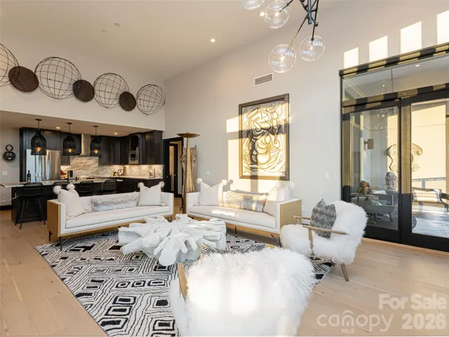 Chef's Kitchen with massive island for entertaining opens directly to Living Room and 2 furnished balconies