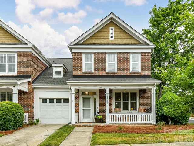 Charming end unit townhome with an  inviting covered front porch offers timeless curb appeal in a sought-after Lake Norman neighborhood.