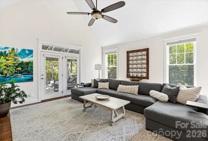 Vaulted ceilings and doors opening to covered back patio