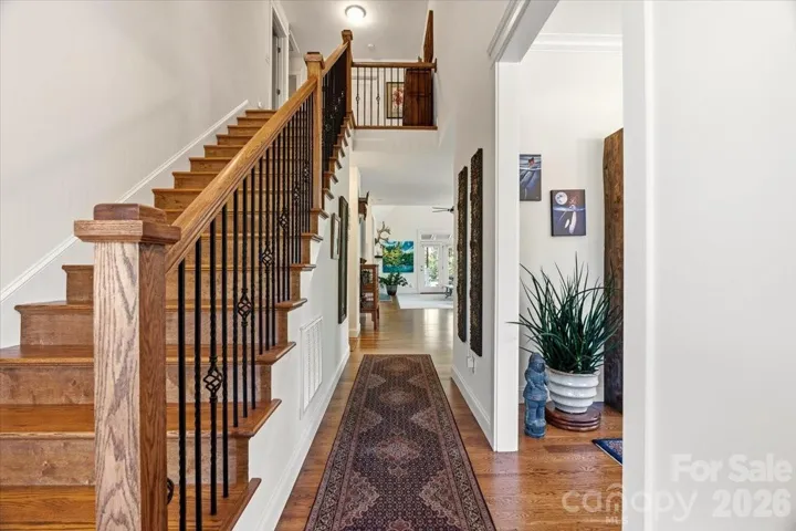 Love these extra wide wooden stairs with beautiful iron railings