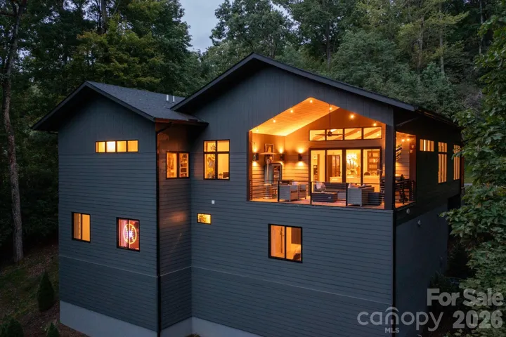 Warm interior glow, showcasing architectural lines and covered deck.