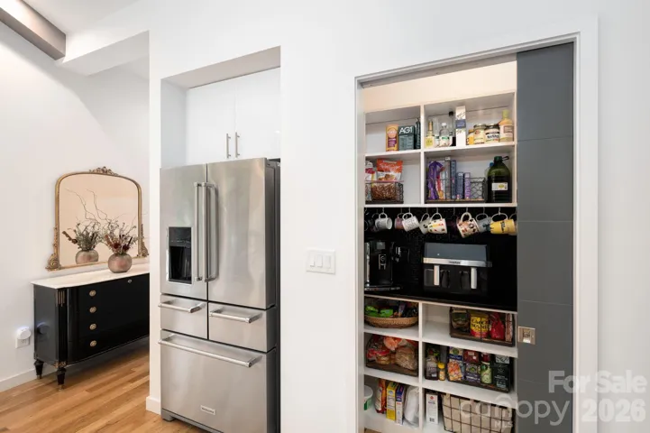 Organized pantry with custom shelving and coffee station.