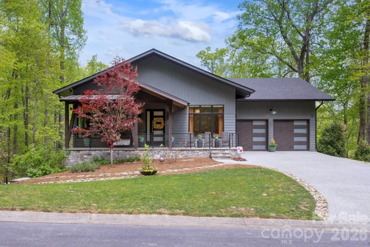Crisp curb appeal surrounded by mature trees.