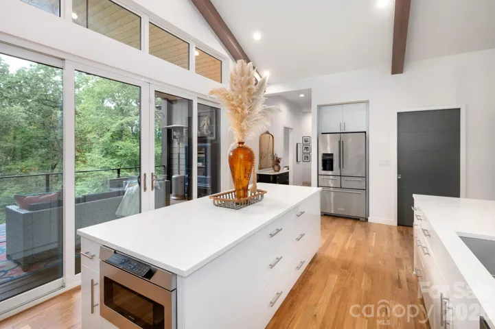 Large kitchen island and sliding glass doors to covered patio.