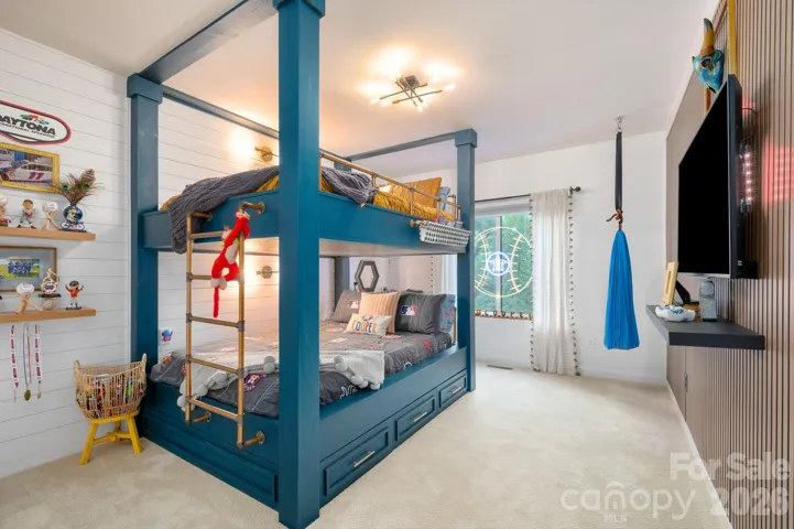 Fun and functional custom-built bunk beds with shiplap walls, ideal for kids or guests.