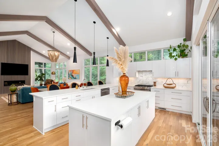 Open-concept kitchen flowing into vaulted great room.