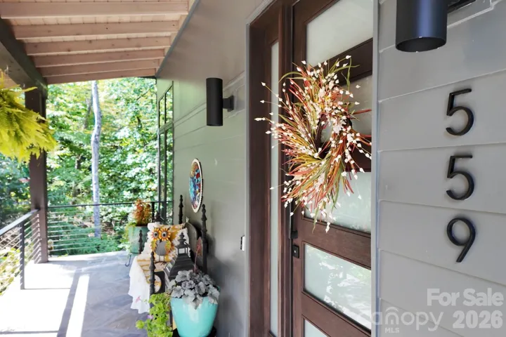 Charming covered front porch welcomes you home and offers a peaceful spot to take in the picturesque landscape.