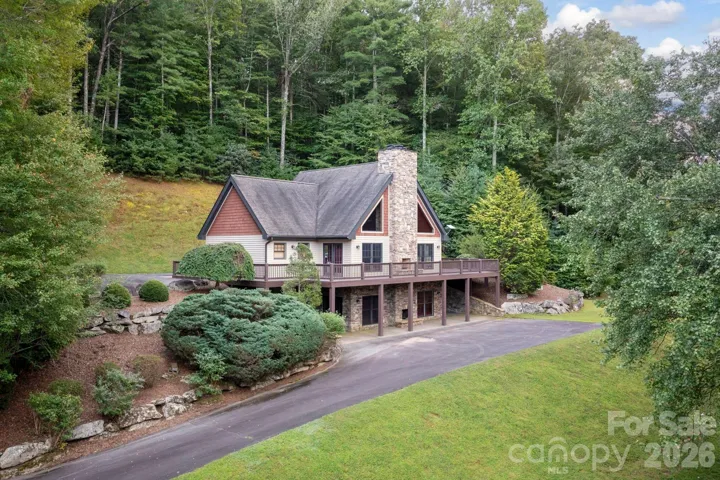 Lodge-style community clubhouse with stone fireplace and expansive deck.