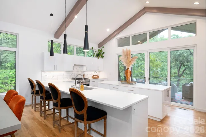 Sleek kitchen with quartz countertops and bar seating.